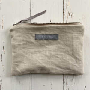 freehand machine embroidered linen pouch embroidered with wild flowers and stitched by textile artist sarah becvar