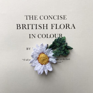 freehand machine embroidered daisy brooch embroidered by textile artist Sarah beaver a unique product made entirely out of embroidery
