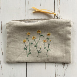 freehand machine embroidered linen pouch embroidered with wild flowers and stitched by textile artist sarah becvar