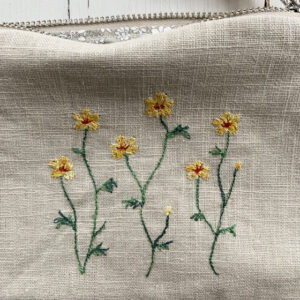 freehand machine embroidered linen pouch embroidered with wild flowers and stitched by textile artist sarah becvar