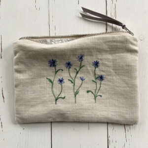 freehand machine embroidered linen pouch embroidered with wild flowers and stitched by textile artist sarah becvar