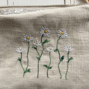 freehand machine embroidered linen pouch embroidered with wild flowers and stitched by textile artist sarah becvar