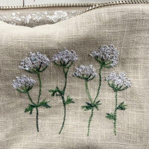 freehand machine embroidered linen pouch embroidered with wild flowers and stitched by textile artist sarah becvar