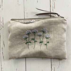 freehand machine embroidered linen pouch embroidered with wild flowers and stitched by textile artist sarah becvar
