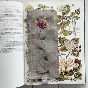 freehand machine embroidered linen flower freehand machine embroidered linen bookmark designed and stitched by textile artist sarah Becvar unique and handmade